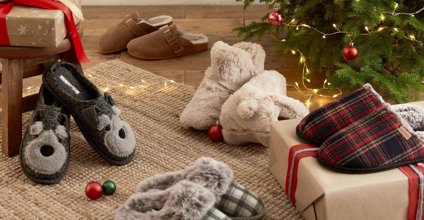 A selection of women's & men's slippers; dog character mules, fluffy boots, checked mules & snug house shoes.