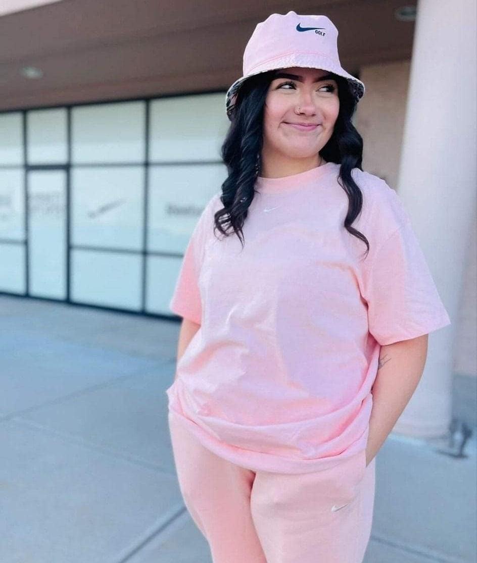 Woman in Nike apparel and hat