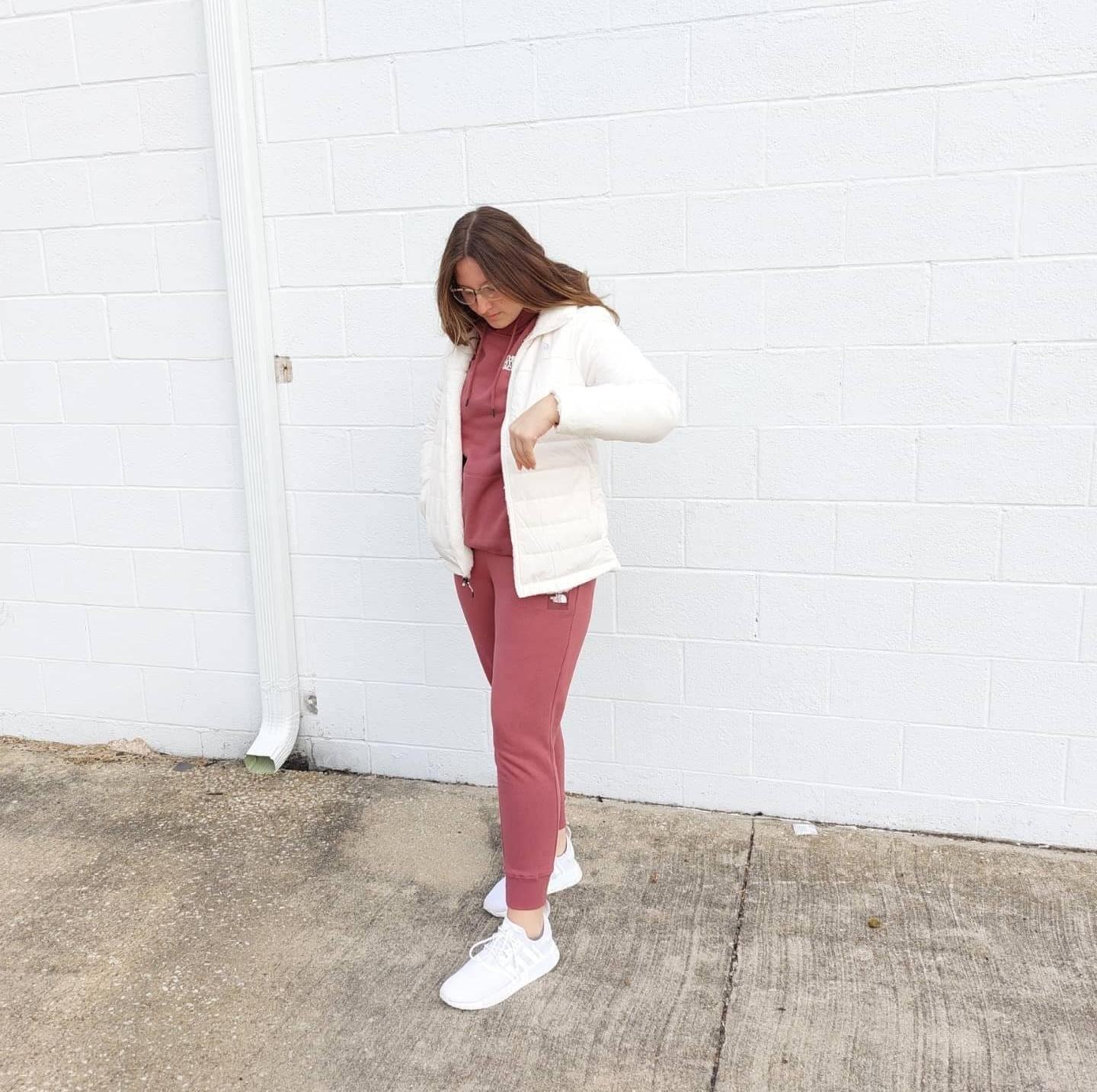 Woman in The North Face Apparel and adidas Sneakers