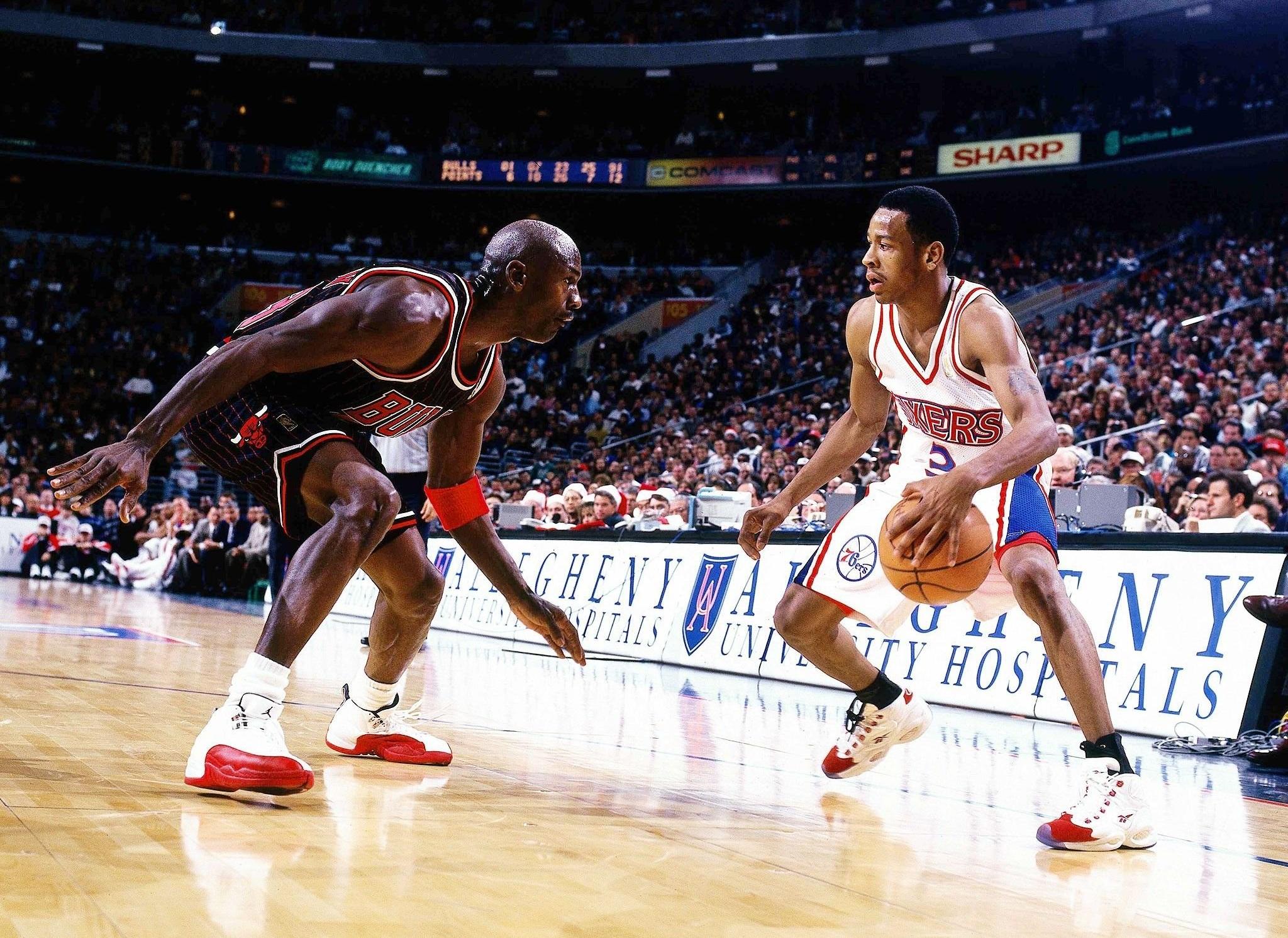 Allen Iverson and Michael Jordan on basketball court - courtesy of https://wallpaperaccess.com/allen-iverson