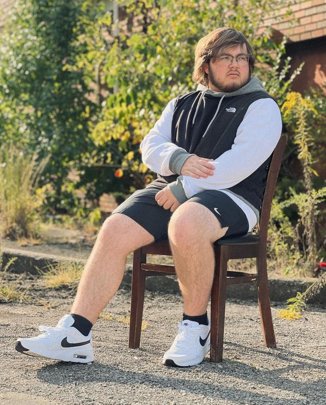 Man in The North Face hoodie, Nike shorts, and Nike sneakers