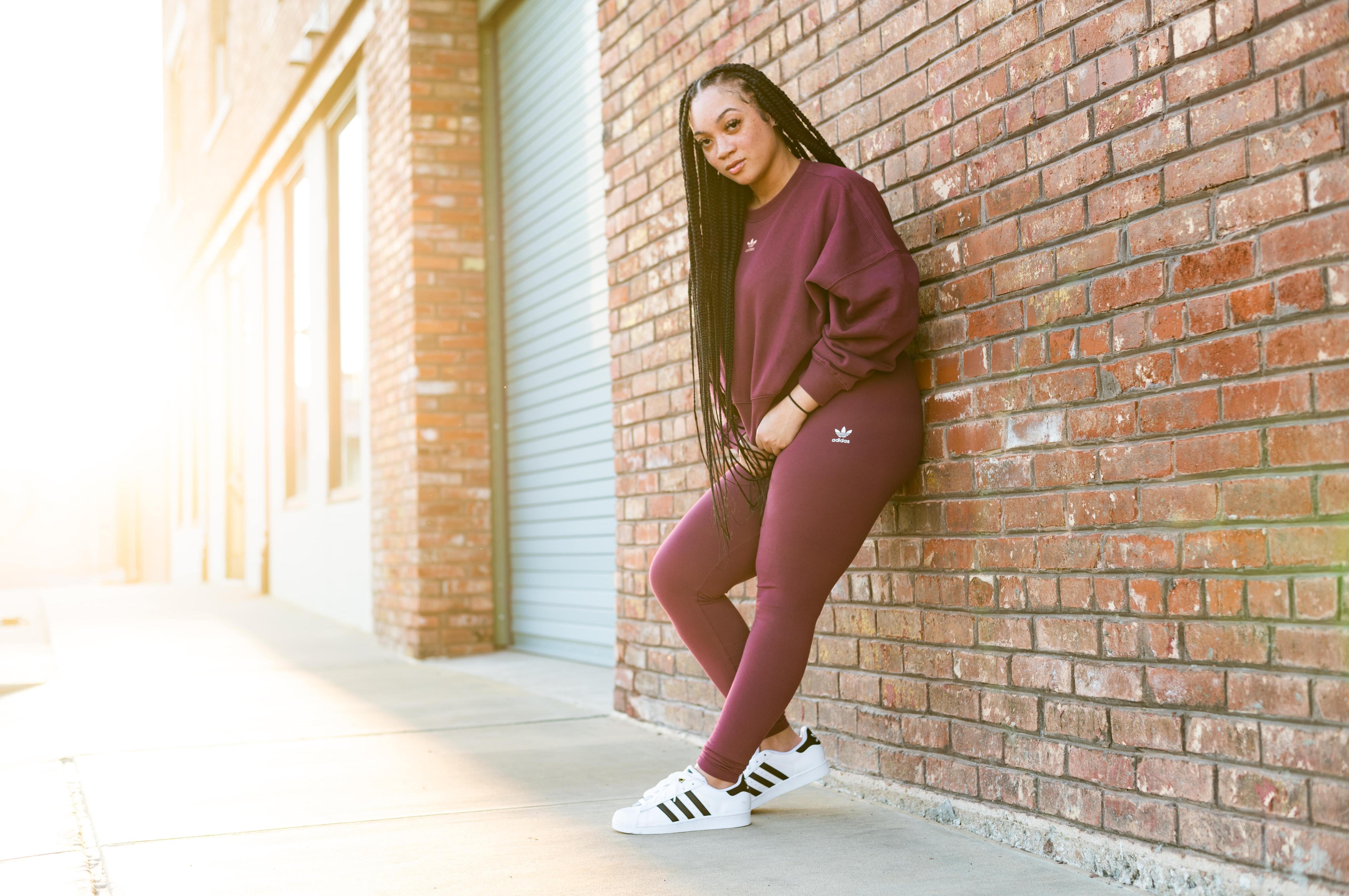 Woman in adidas Superstars, adidas leggings, and adidas sweatshirt.