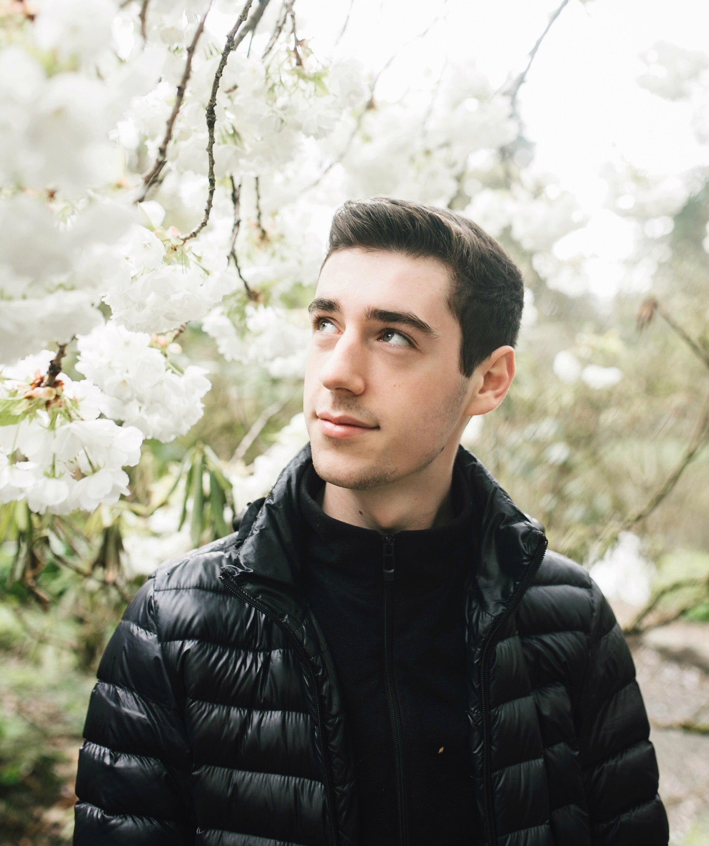 Man in puffy down jacket and zip up jacket.