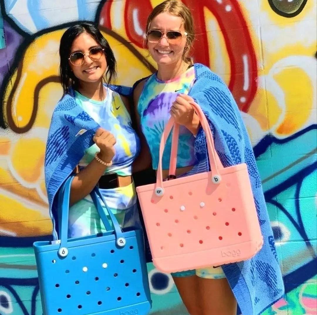 Women in Nike Tye Dye Cropped Top, Nike Tye Dye Bike Shorts, and Bogg Bags
