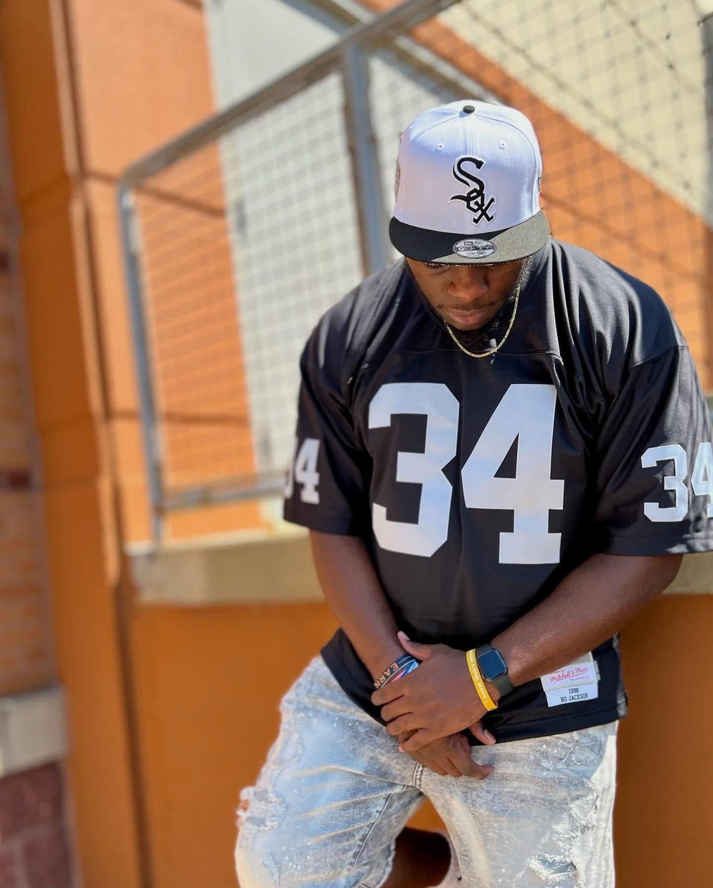 Man in SOX hat and NFL jersey