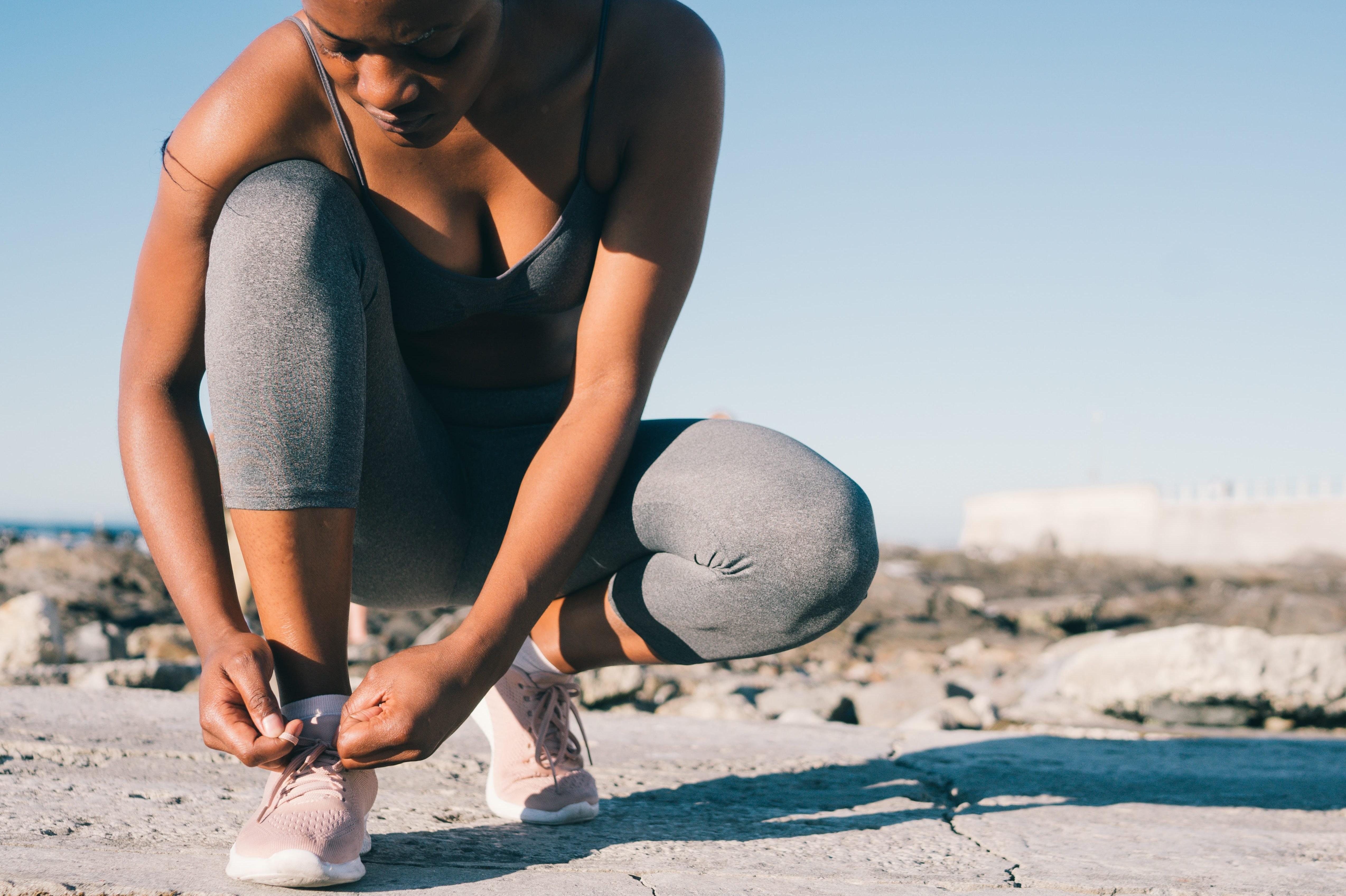 Woman tying shoe