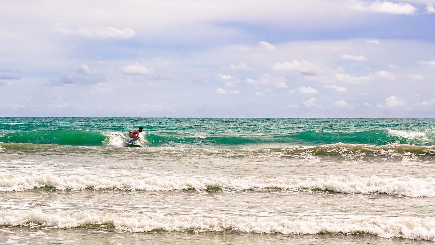 Darren from FatFace Head Office, surfing at one of the islands in Koh Lanta