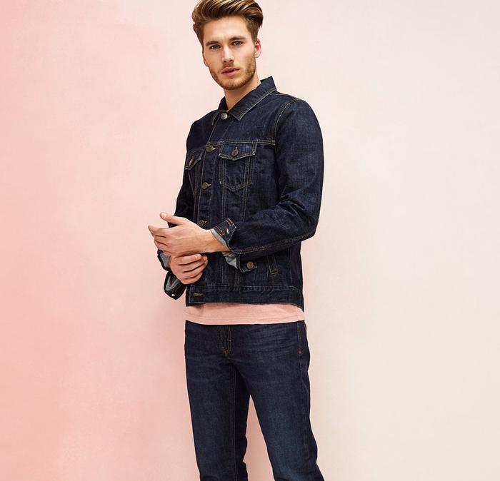 A male model wears double denim with a pink tee poking out