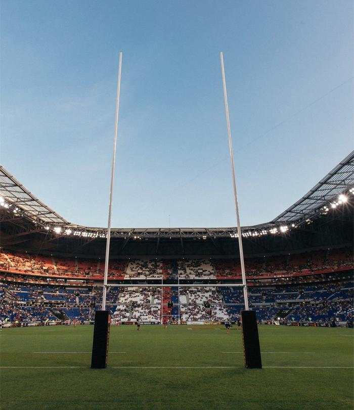 The white rugby goal posts on a rugby field