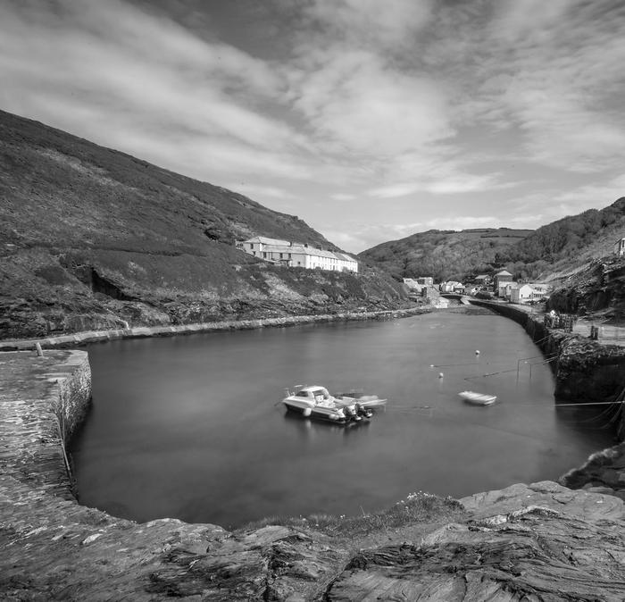The harbour of Boscastle, with small boats and cottages in the distance