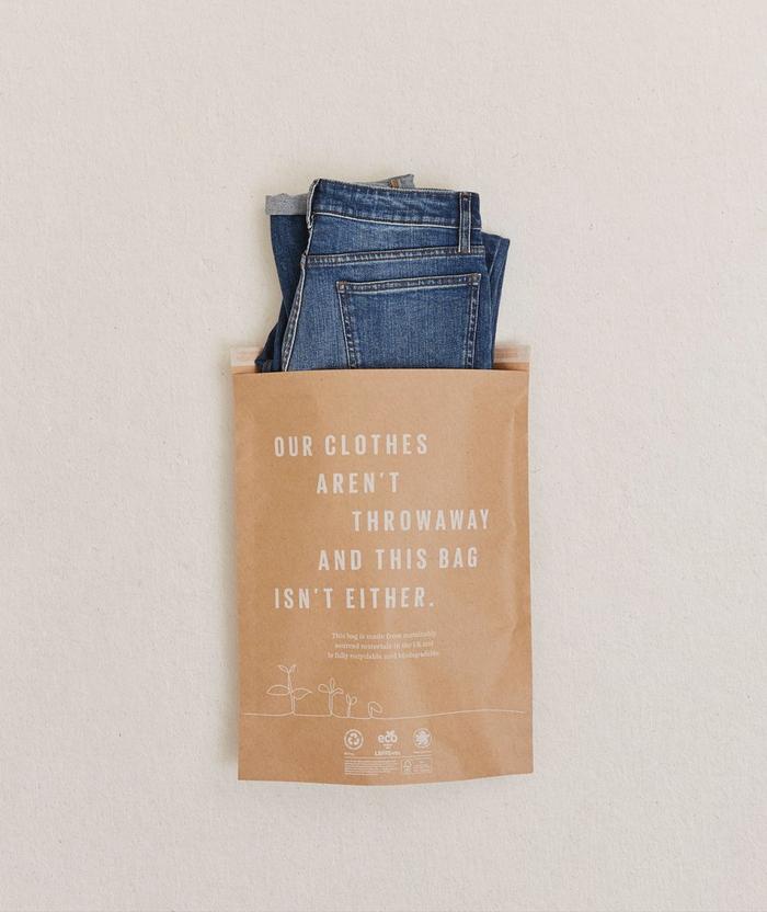 A pair of jeans placed into our new sustainable packaging.