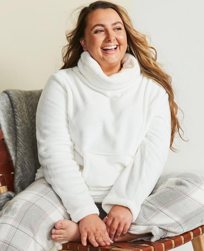 Instagrammer Abee Hague wearing a white snuggle top and check PJ bottoms.