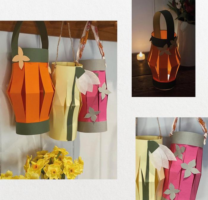 Collage of hanging paper lanterns in orange, yellow, green & pink, decorated with cutout paper flowers.