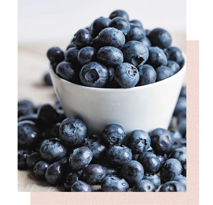 A small bowl overflowing with fresh blueberries.