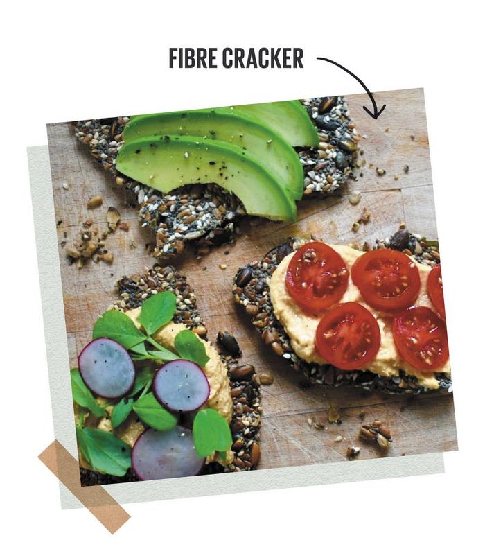 High-fibre crackers made of various seeds, topped with sliced avocado, radish & cherry tomatoes.