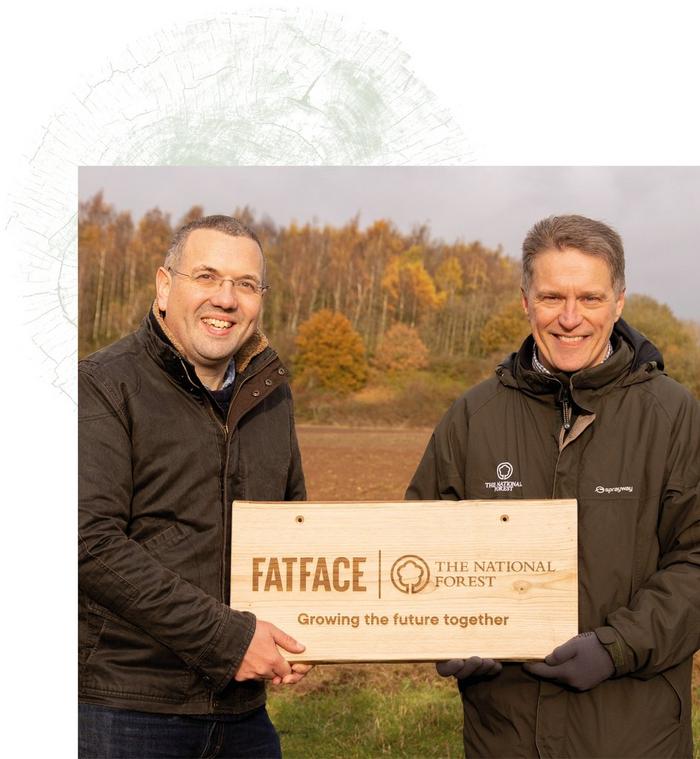 FatFace CEO Will Crumbie & a reprentative from the National Forest, holding a wooden plaque commemmorating the partnership.