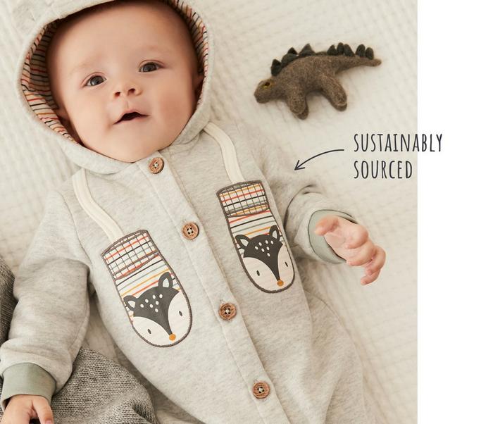 Baby wearing a warm button-up hooded romper with animal-patterned mitts design. Sustainaby sourced.