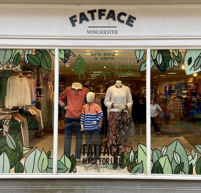 A FatFace shop front, with a hand painted window display celebrating Winchester Green Week.