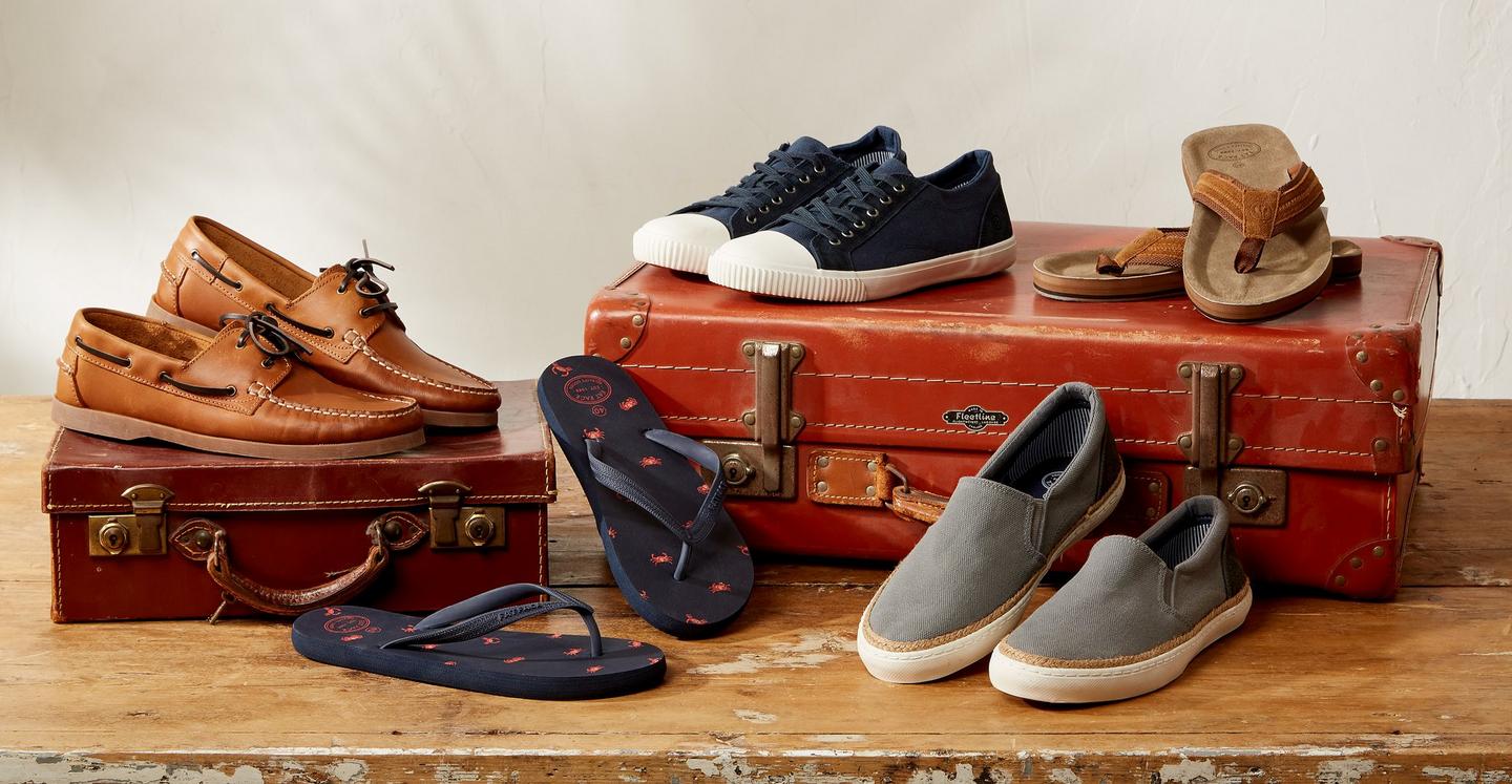 A collection of men's shoes - including leather boat shoes, flip flops & canvas trainers.