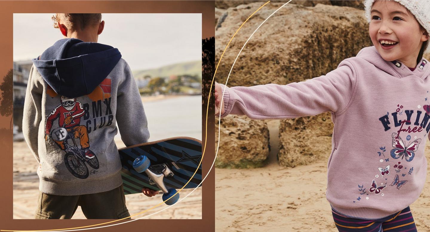 A boy wearing a gray hoodie with navy hood & 'BMX Club' graphic. A girl wearing a lilac hoodie with 'Flying Free' graphic.