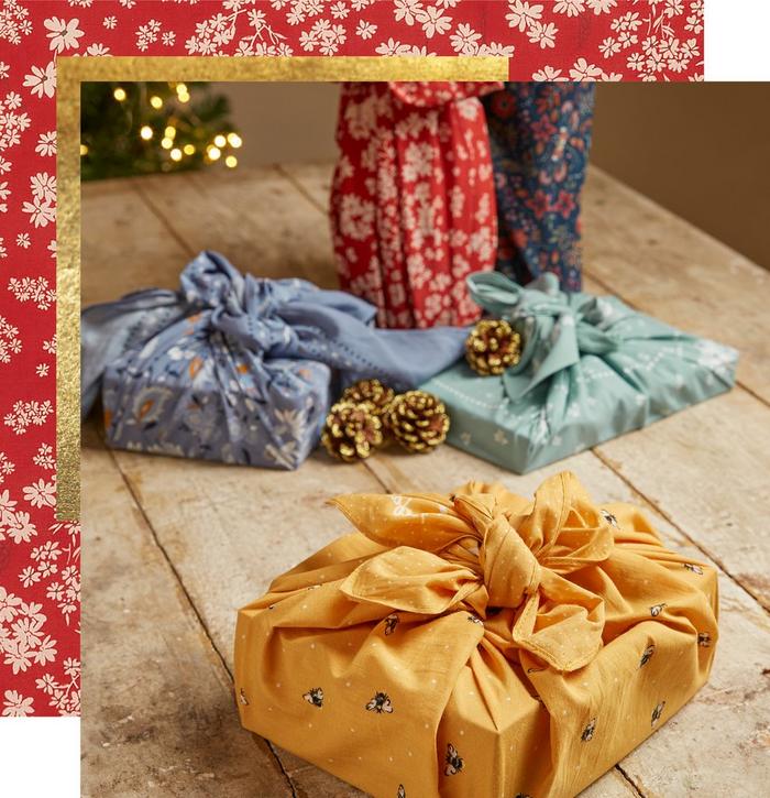 Gift boxes & bottles wrapped in boldly colored fabric wraps with floral & bee prints.