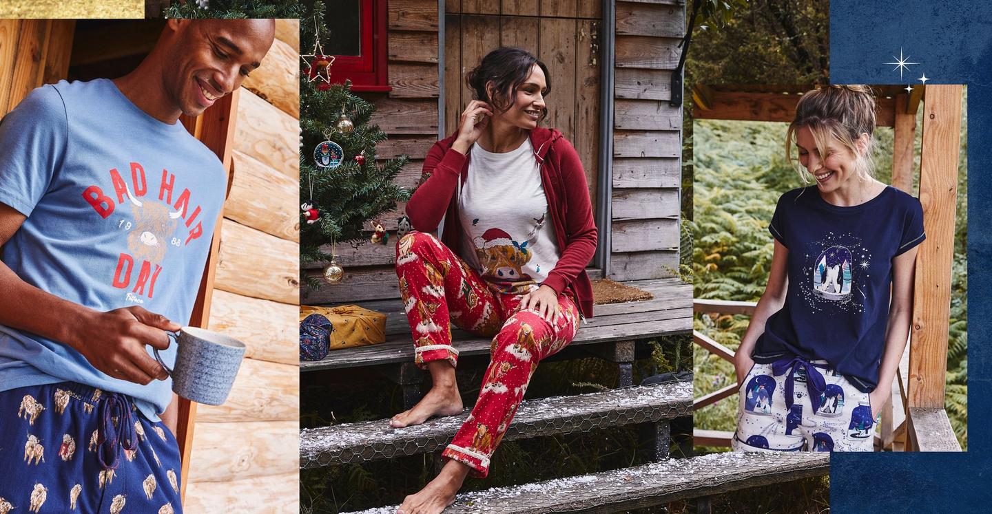 A man & woman wearing Hamish the highland cow character PJs. A woman wearing navy & white PJs with polar snow globe design.
