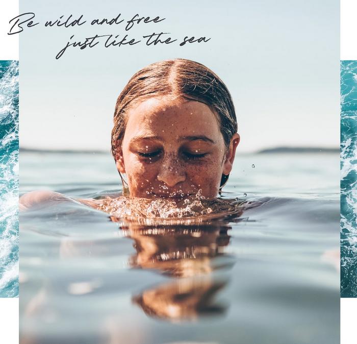 A woman swimming in calm open waters. Be wild and free, just like the sea.