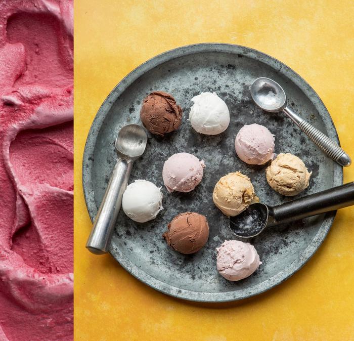 Scoops of different flavoured ice creams laid out on a stone dish.