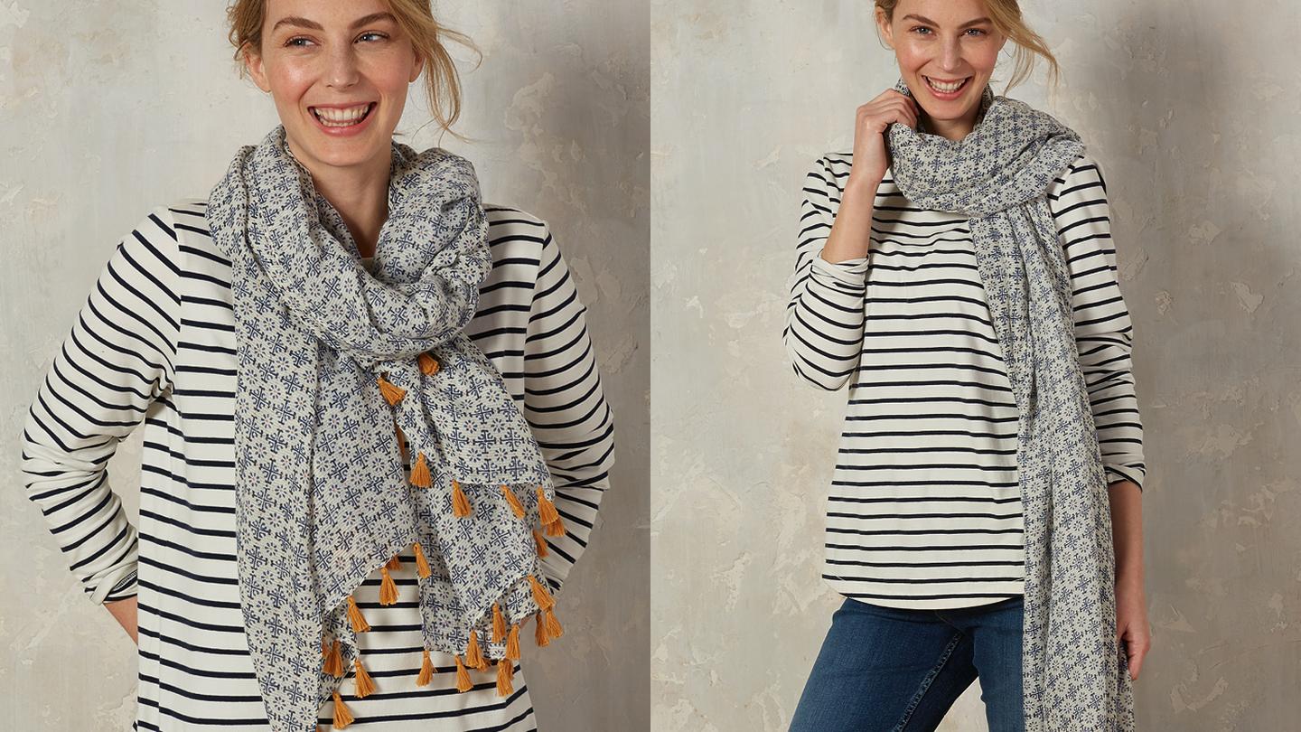 A printed scarf paired with classic jeans and a Breton tee