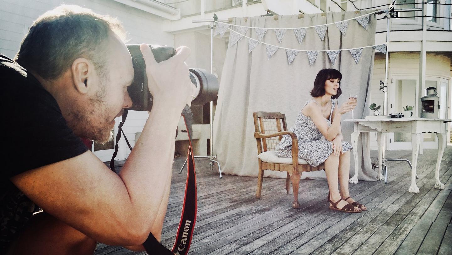 A model on set, with the Liberty London Fabrics bunting in the background