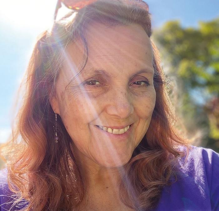 A selfie of the beautiful UK carer Anne, stood in the sunshine.