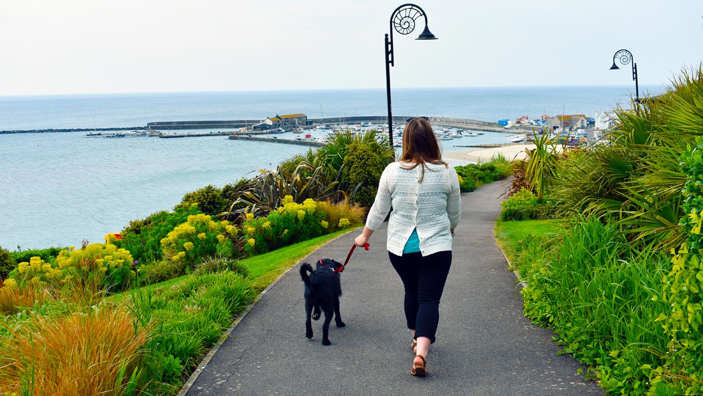 Kayleigh, the store manager at FatFace Lyme Regis, enjoying a coastal walk with her dog along the Jurassic Coast. 