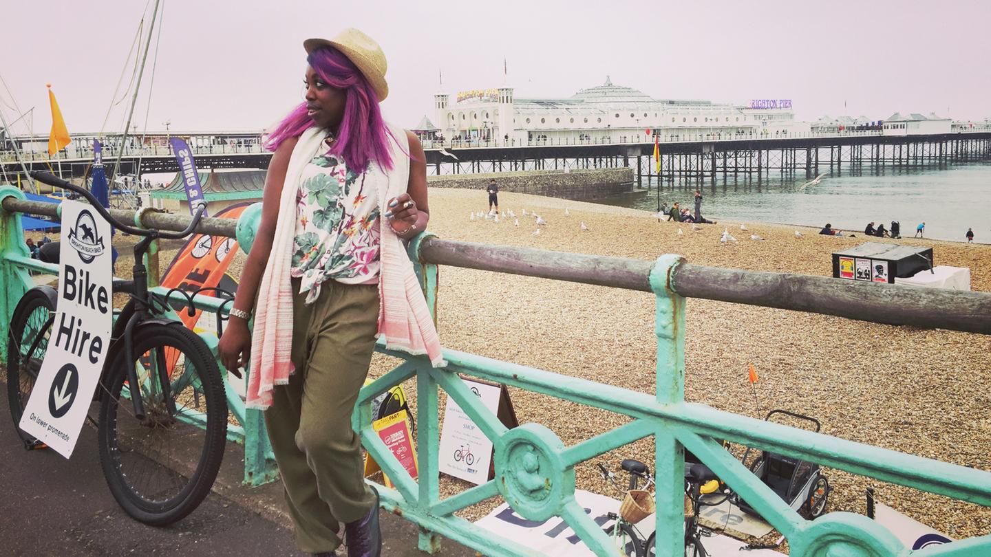 Ebony, who works at the Brighton FatFace store, wearing FatFace clothes as she chills at by Brighton Pier