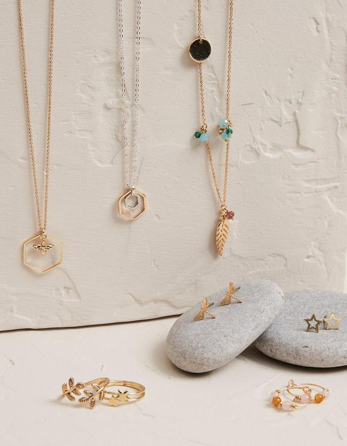 A selection of jewellery inspired by nature, including star rings, dragonfly earrings, and bee-themed necklaces.