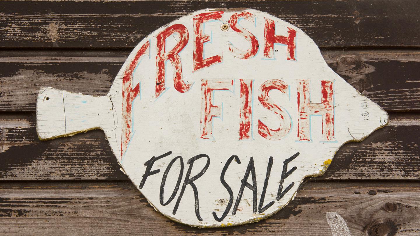 A 'fresh fish for sale' shop sign, in the shape of a fish