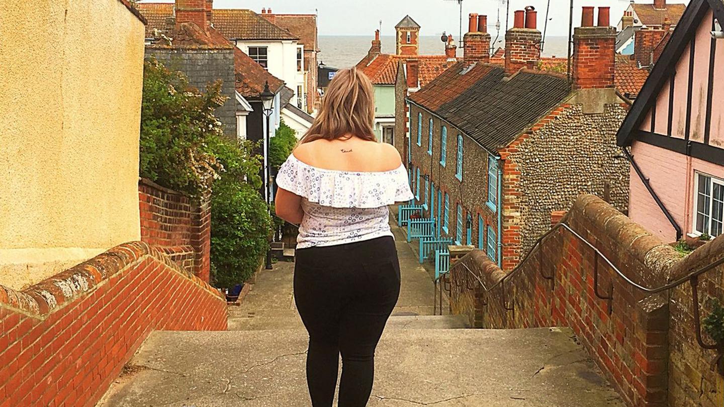 Ellie, who works at the FatFace store in Aldeburgh, taking a walk through the local cobbled streets in FatFace clothes