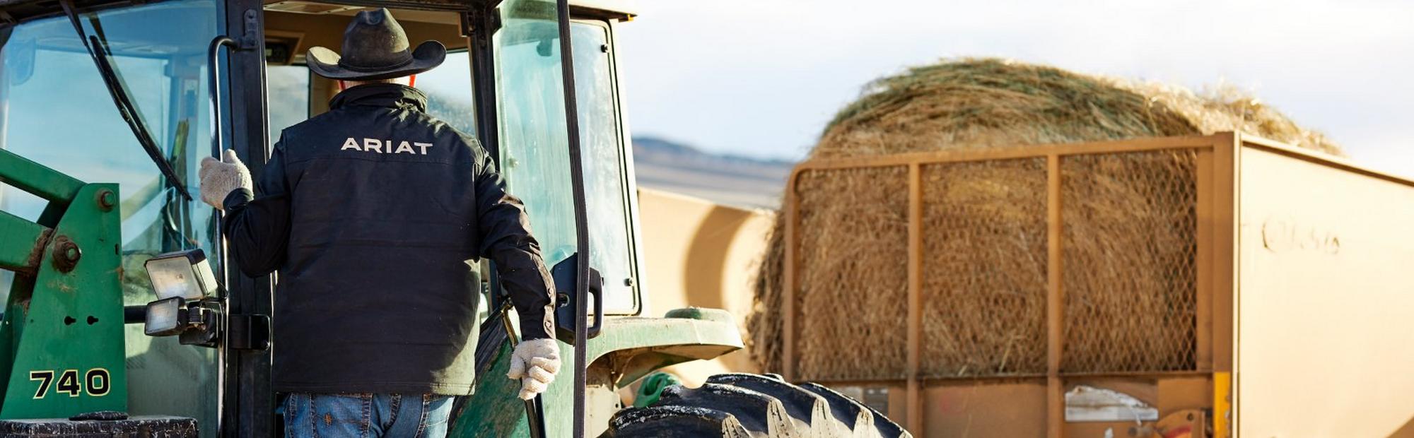 Farmer wearing Ariat Softshell Jacket on tractor