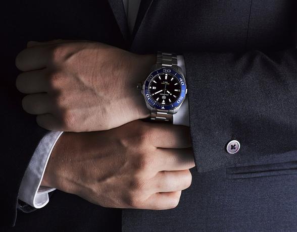 TAG Heuer Watch Buying Guide 2019 - man in a suit wearing a TAG Heuer Aquaracer watch