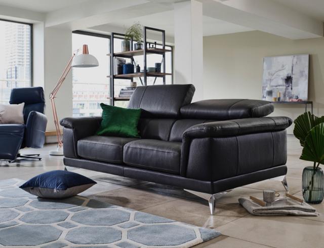 Modern black leather sofa with metal feet