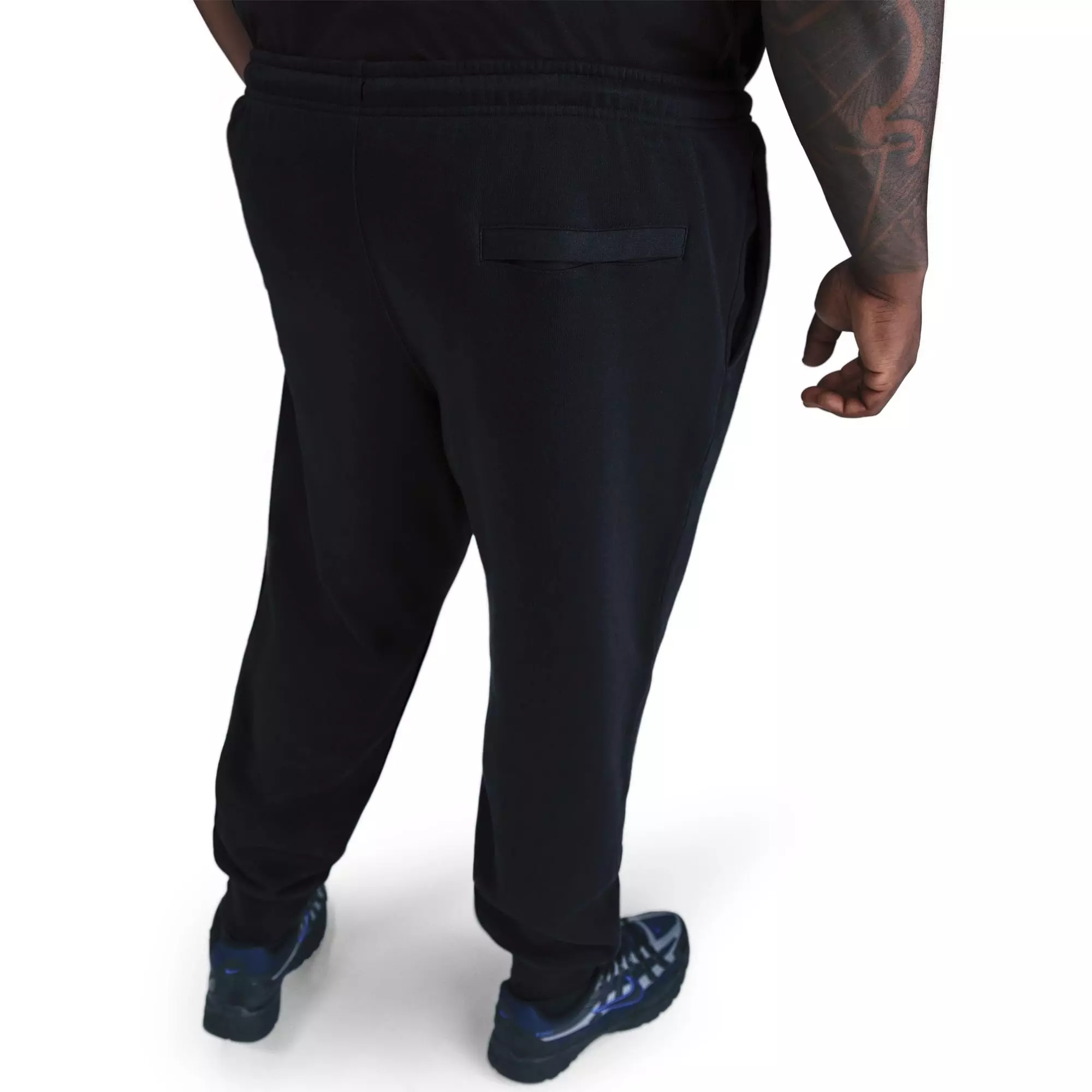 Back view of men's Nike Club Joggers in black showing ribbed cuffs and back pocket detail