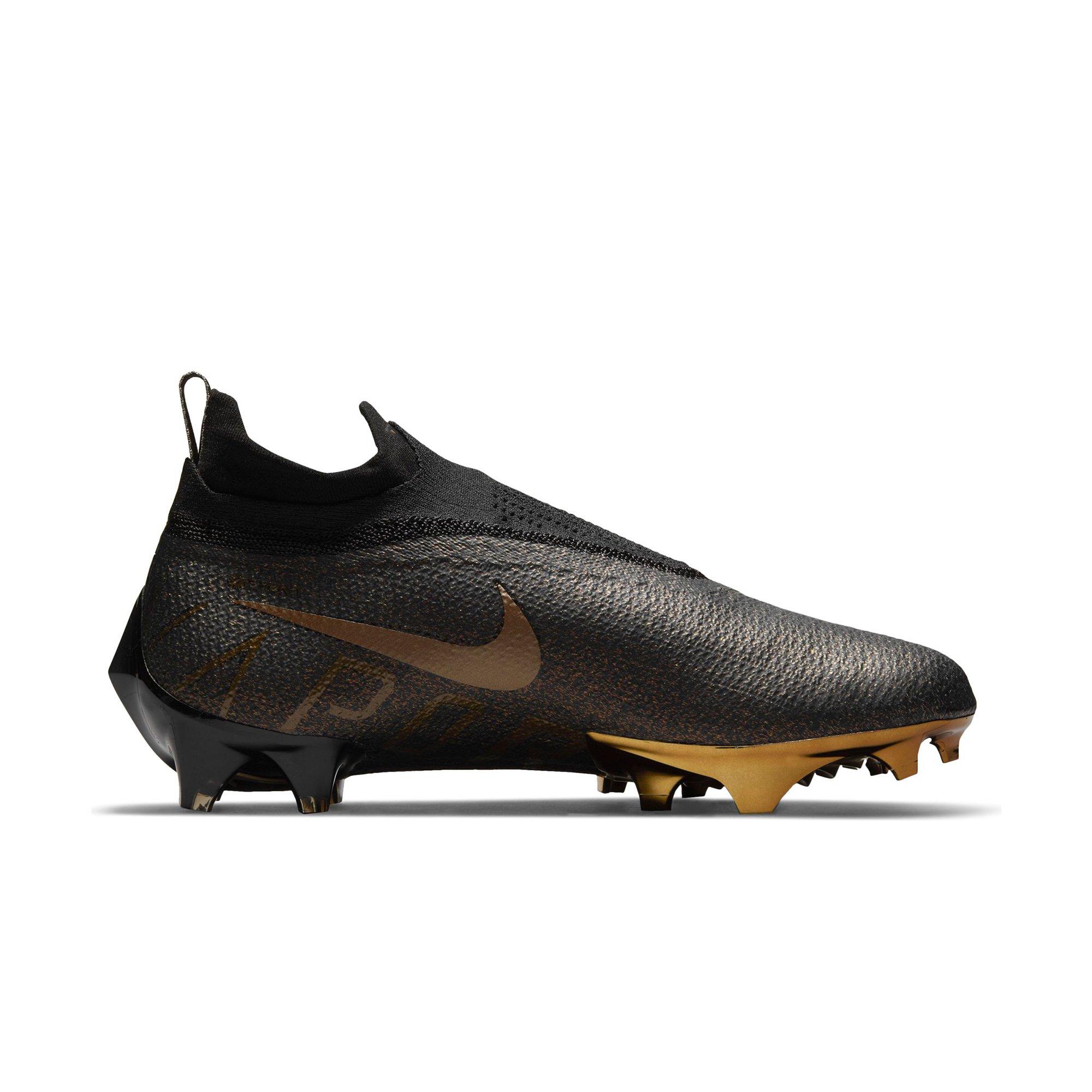 Black and gold 2025 nike football cleats