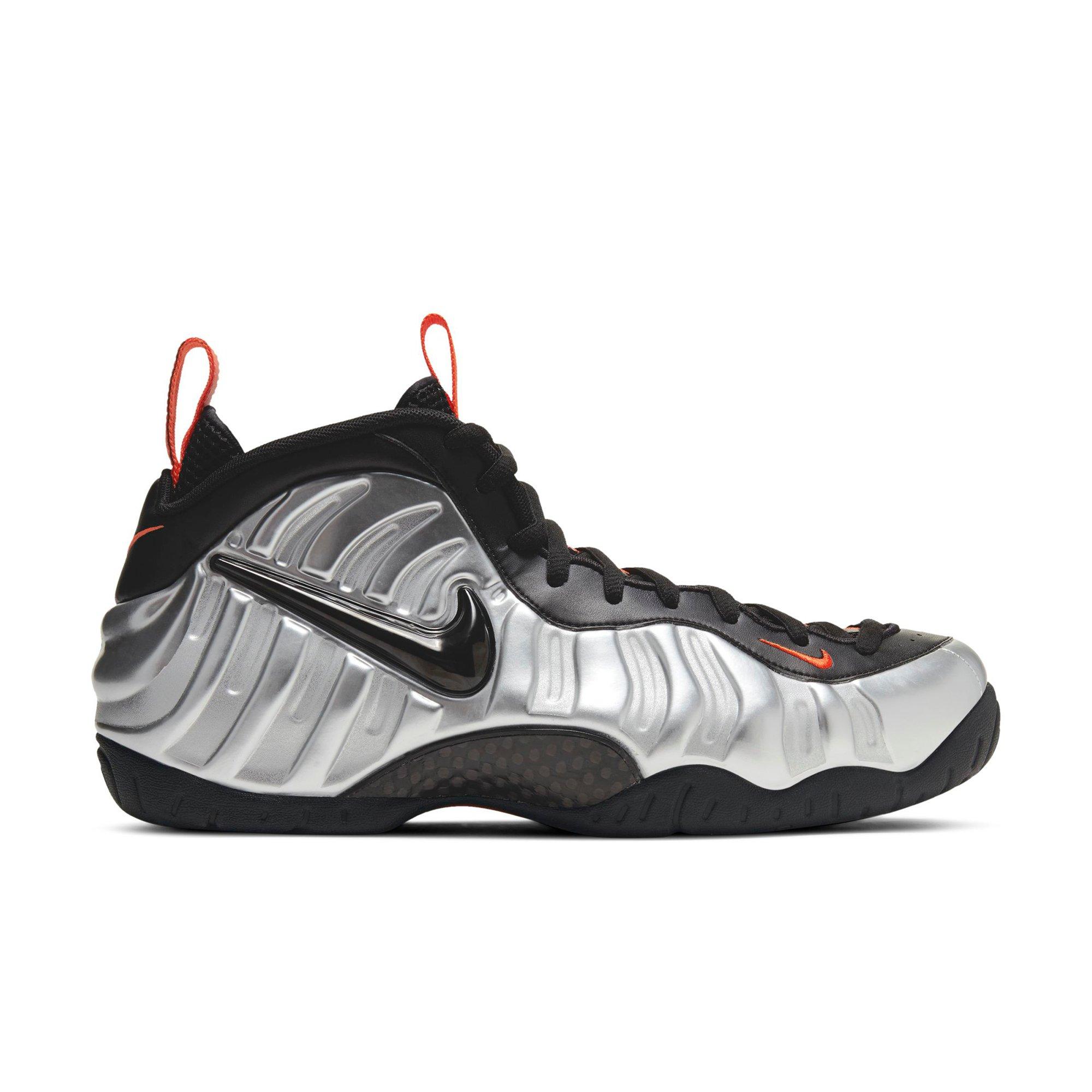 silver black and orange foamposites