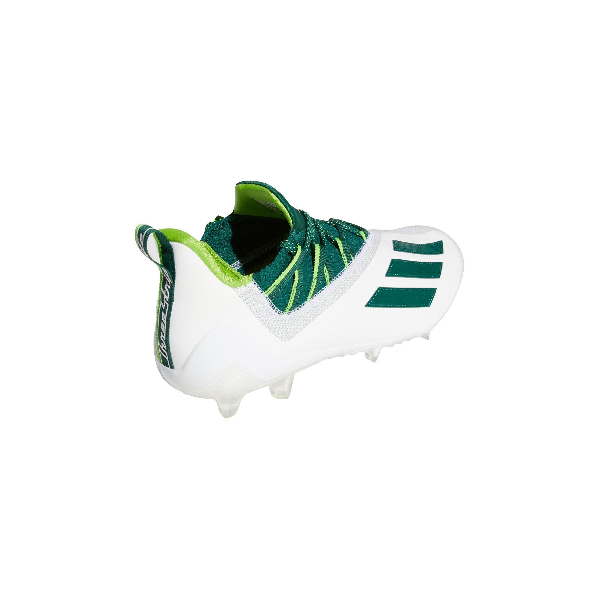 white and green adidas cleats