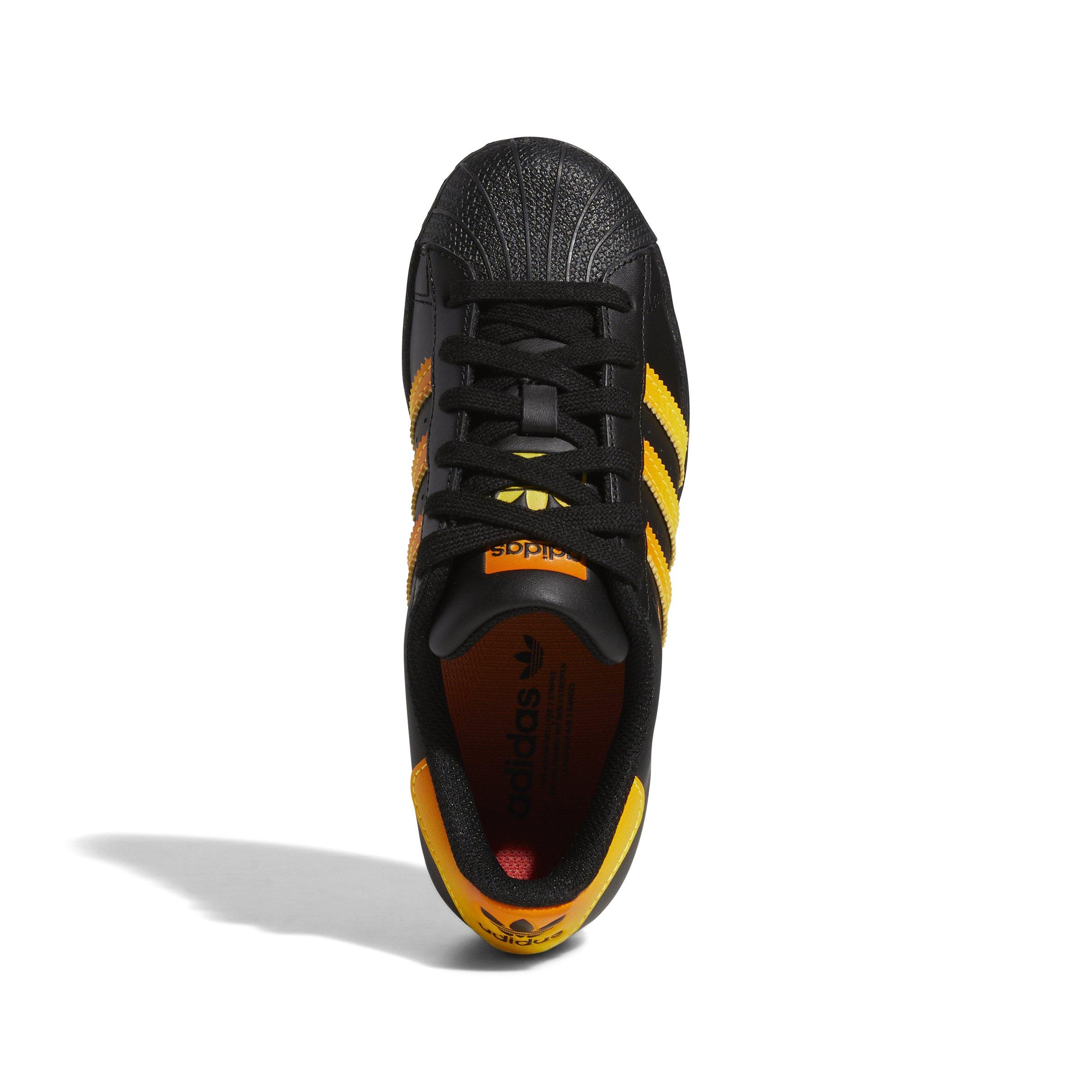 Black adidas with orange hot sale stripes