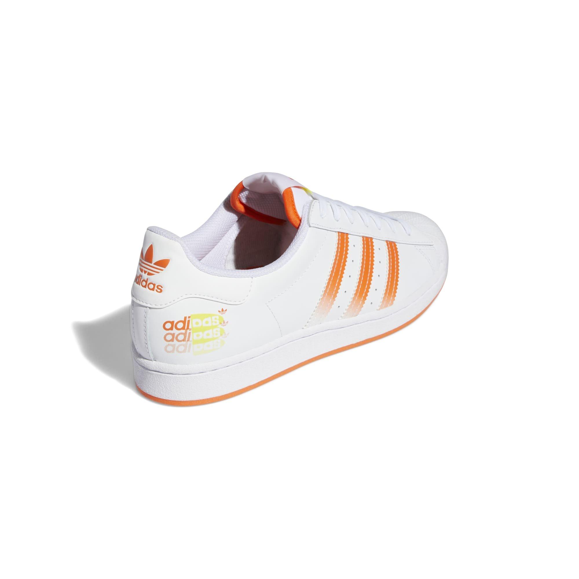 White adidas with sales orange stripes