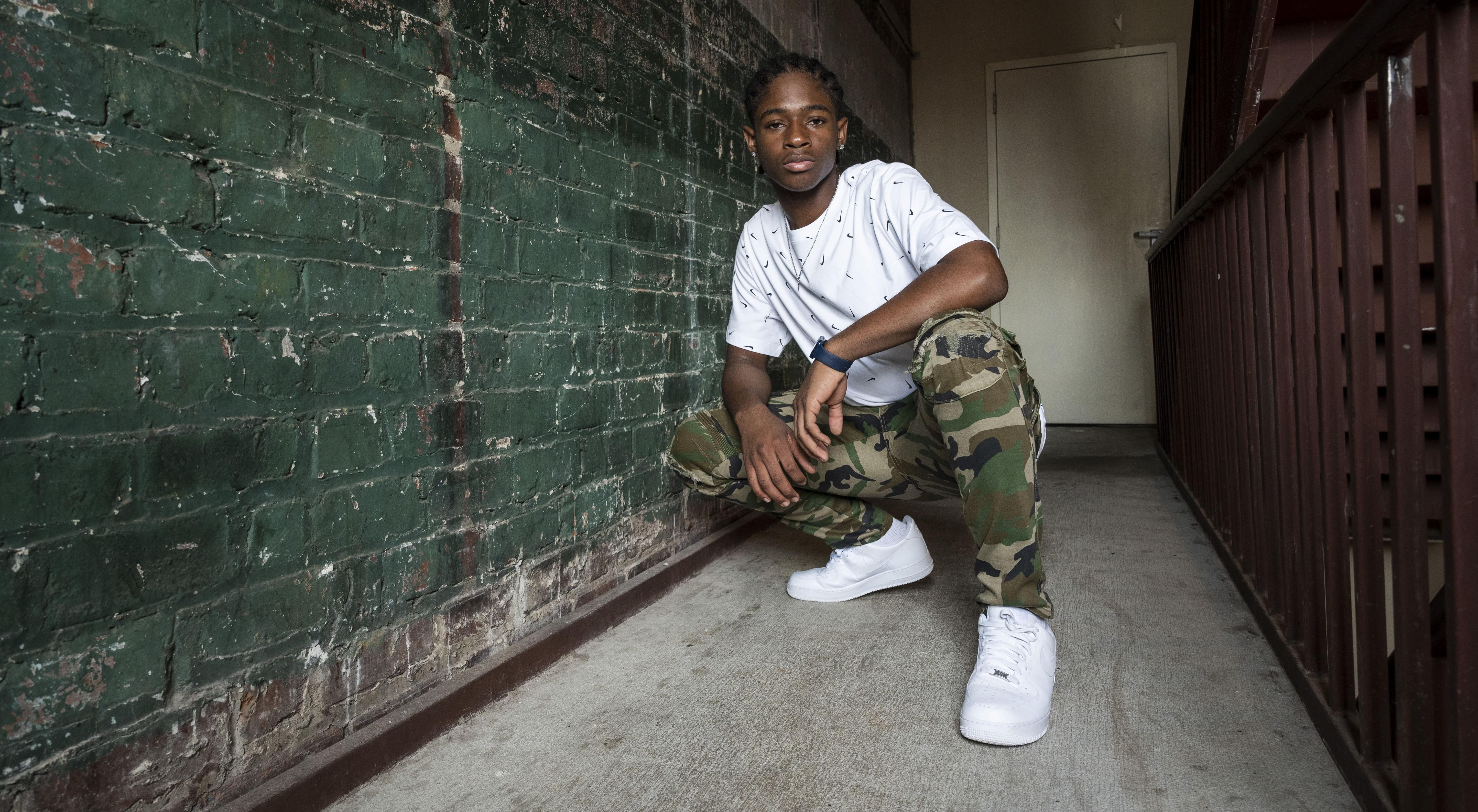 Man in air force 1s, Camo Joggers, and Nike shirt
