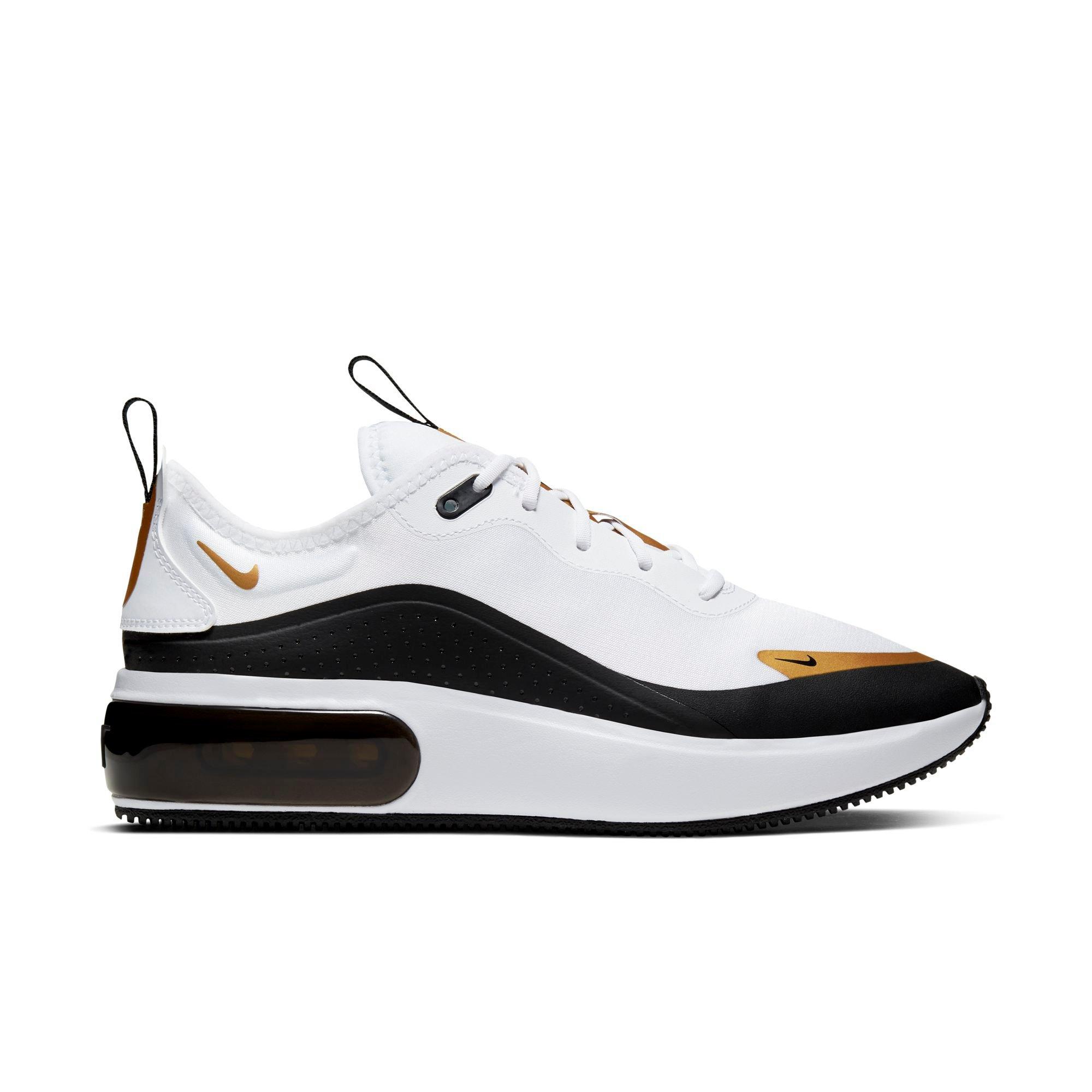 gold black and white nike shoes