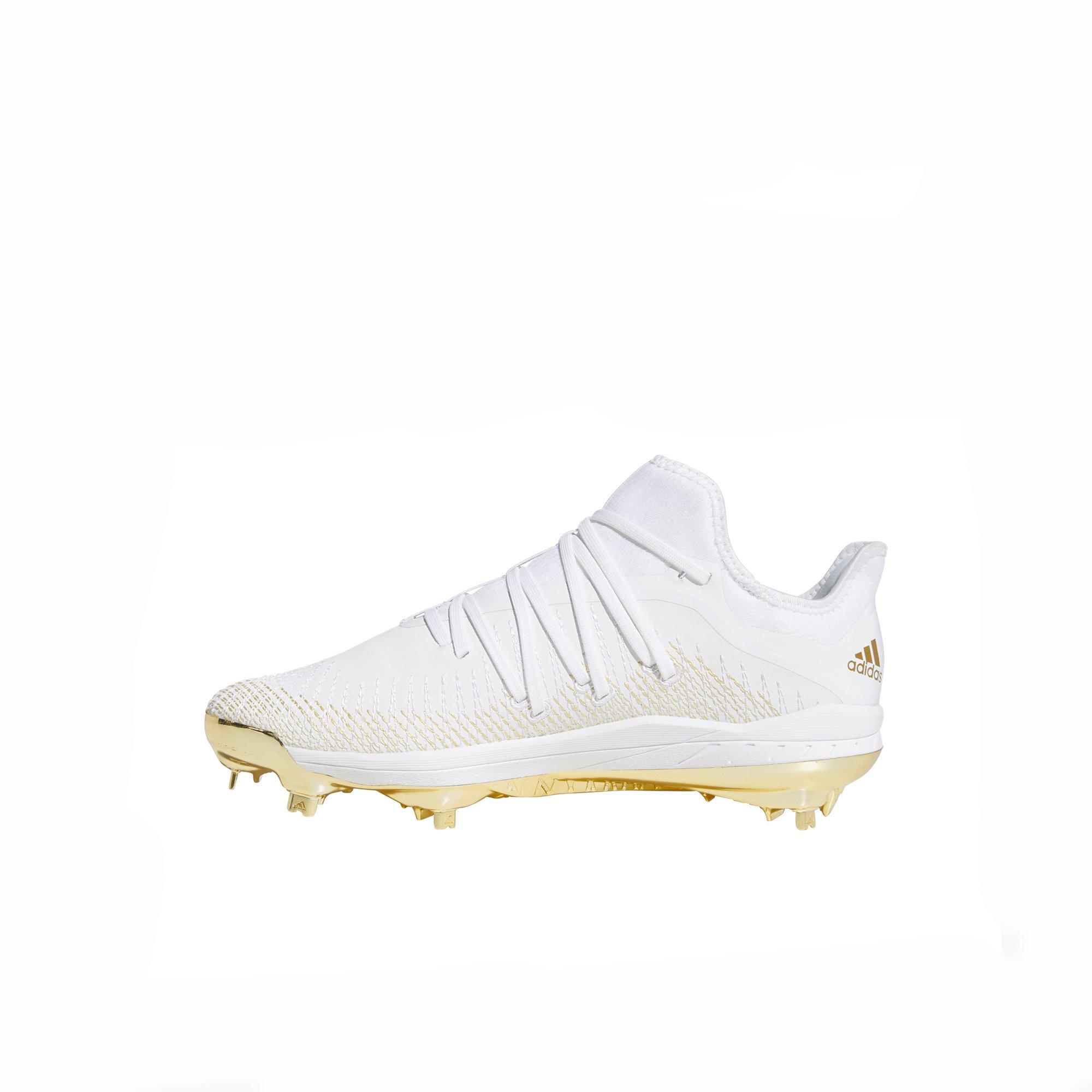 white and gold metal cleats