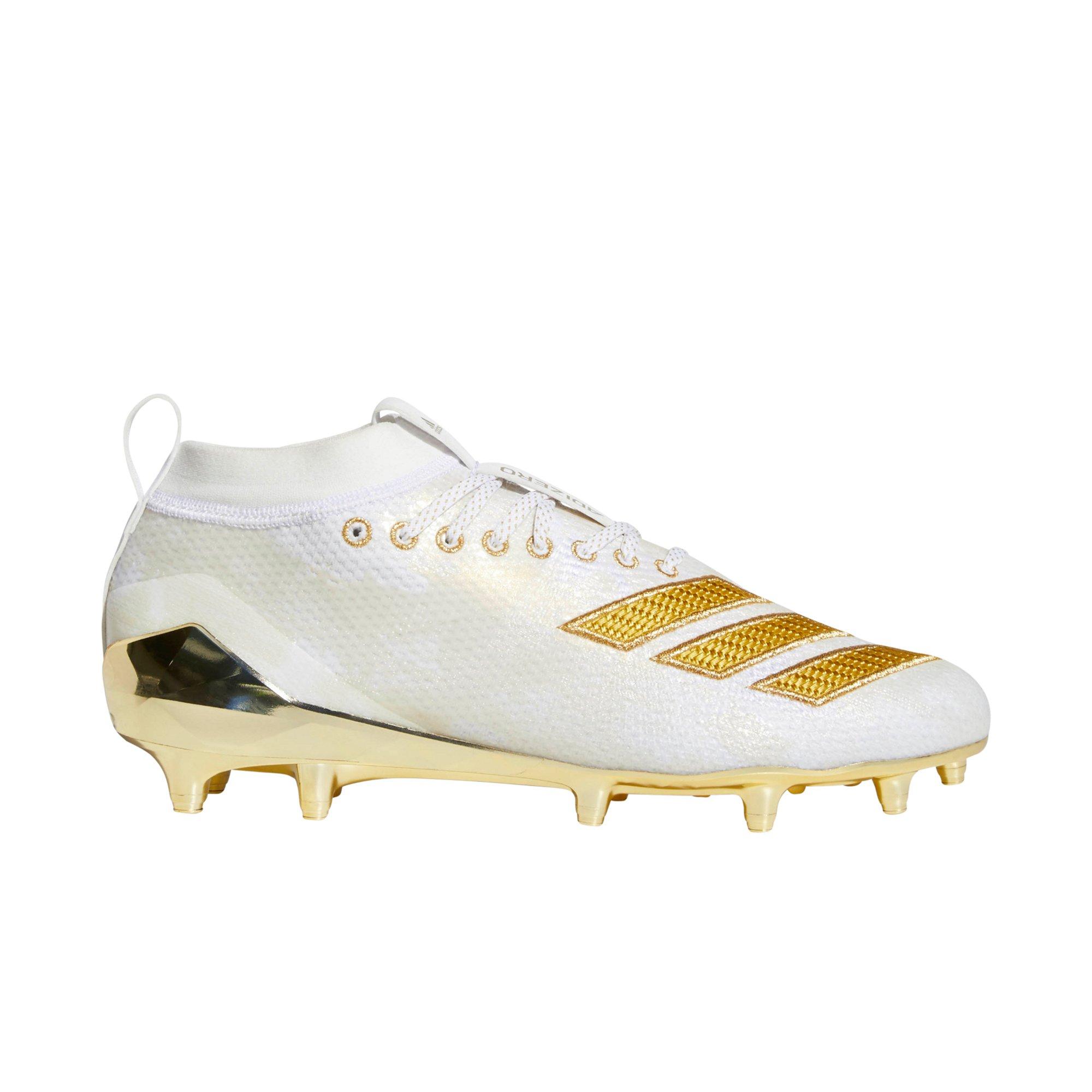 white football cleats with gold bottom