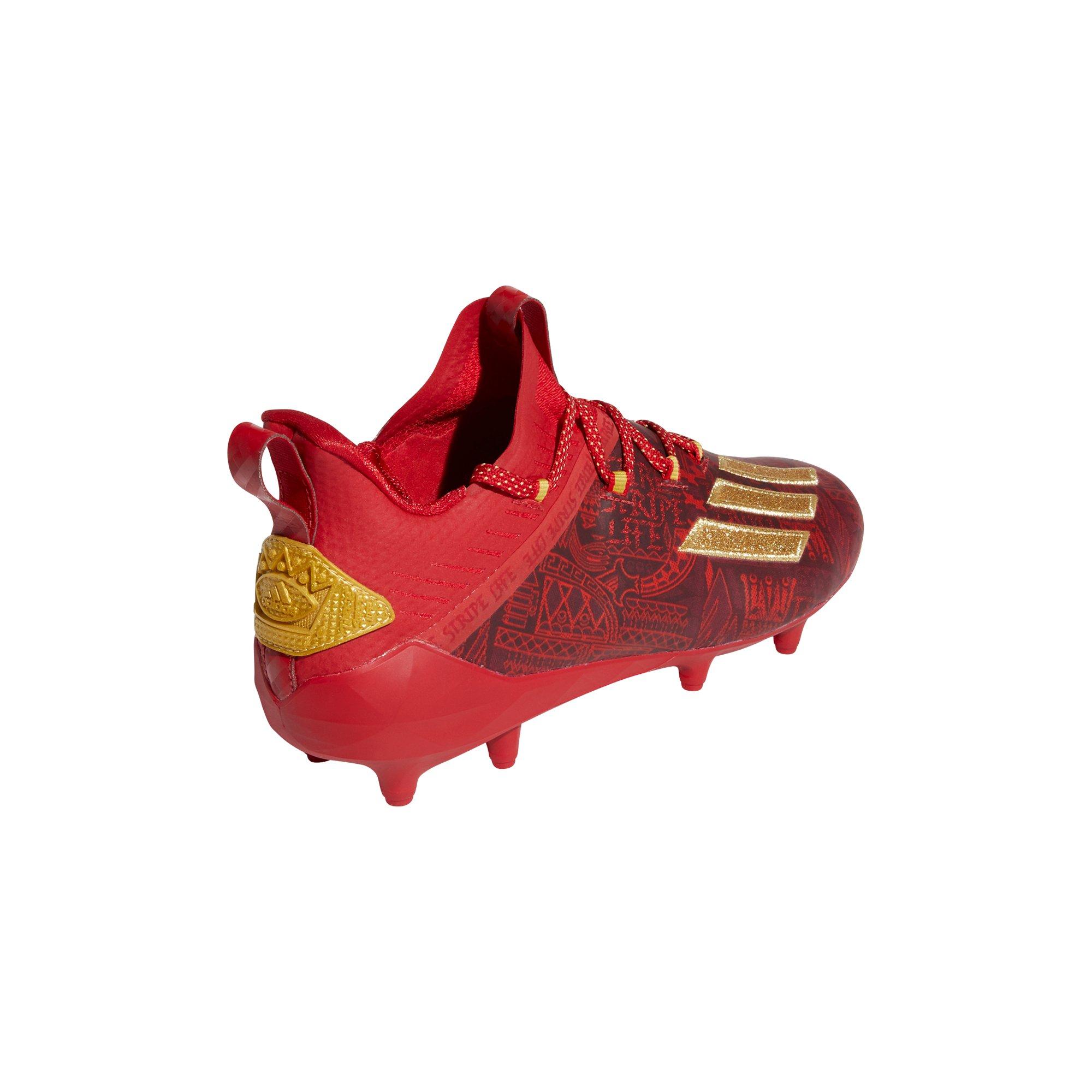 gold and red football cleats